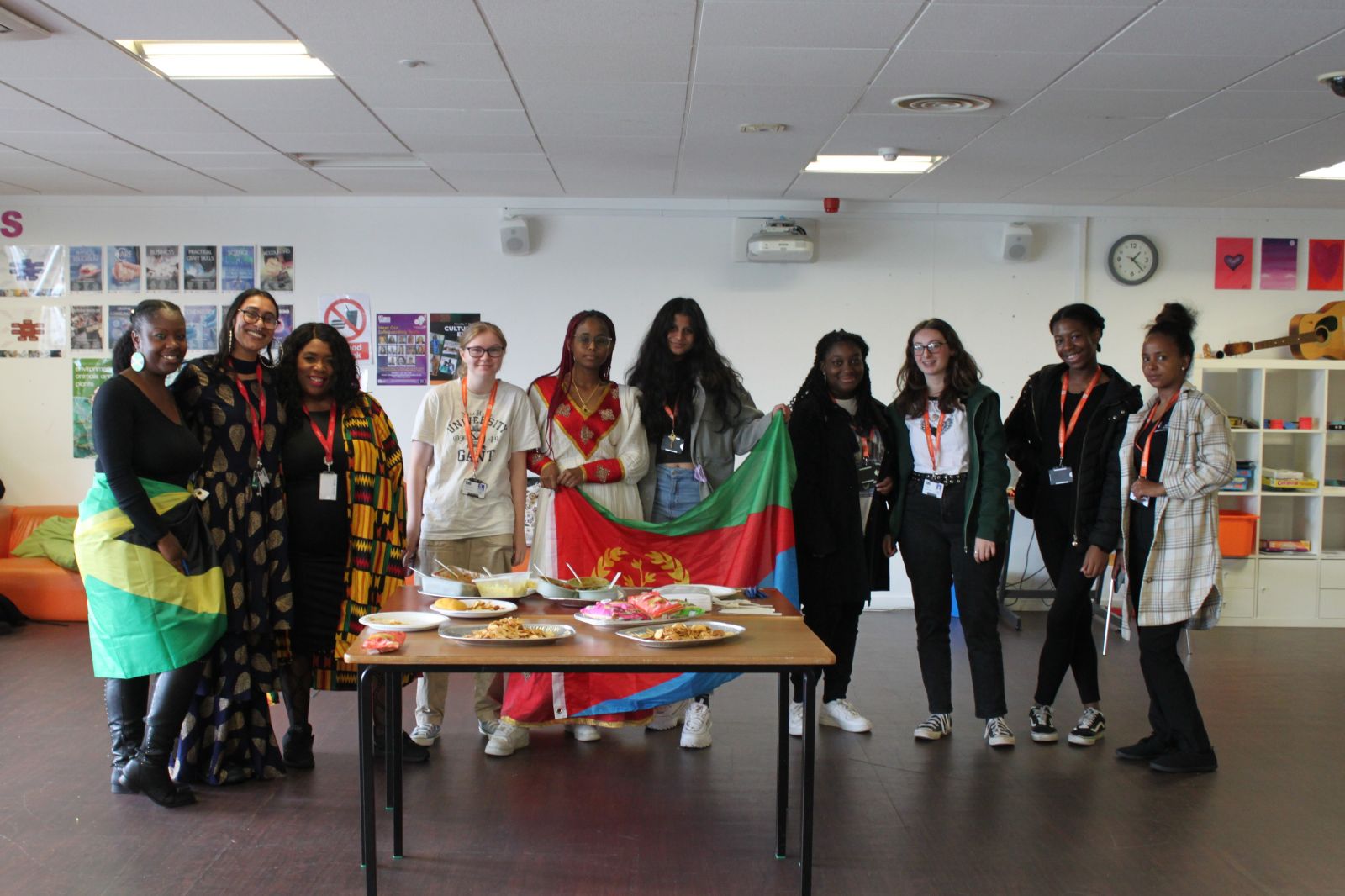 students and staff with flag at cultural event