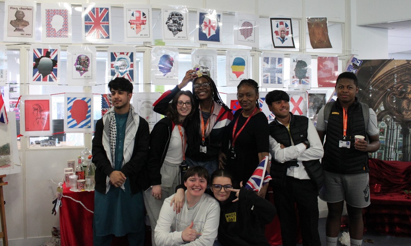 Group of students with coronation art display behind 