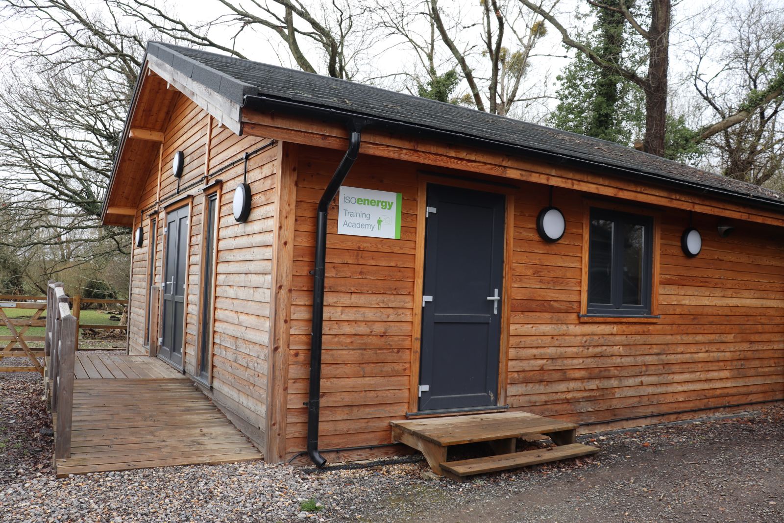 Heat pump training academy - a wooden building with slate roof  