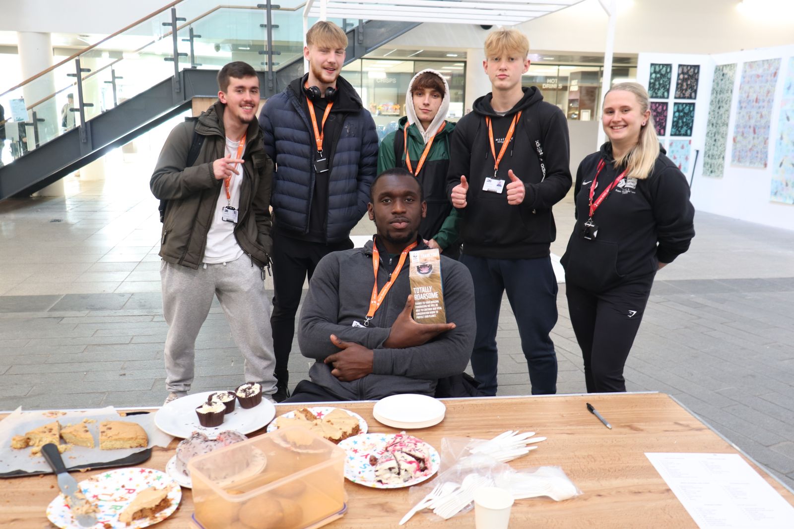 STUDENTS AT FUNDRAISING CAKE SALE